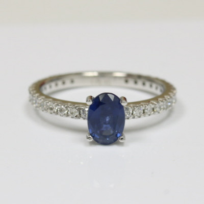 Royal Blue Beauty: Oval Sapphire Ring with Round Diamond Border: 